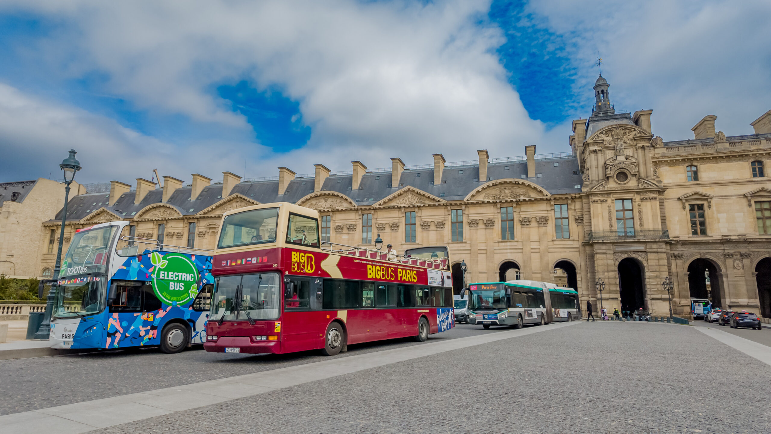 Wheelchair user approaching accessible sightseeing bus ramp in Paris