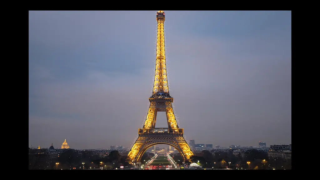 Eiffel Tower illuminated golden against dark winter sky in Paris Eiffel Tower illuminated golden against dark winter sky in Paris